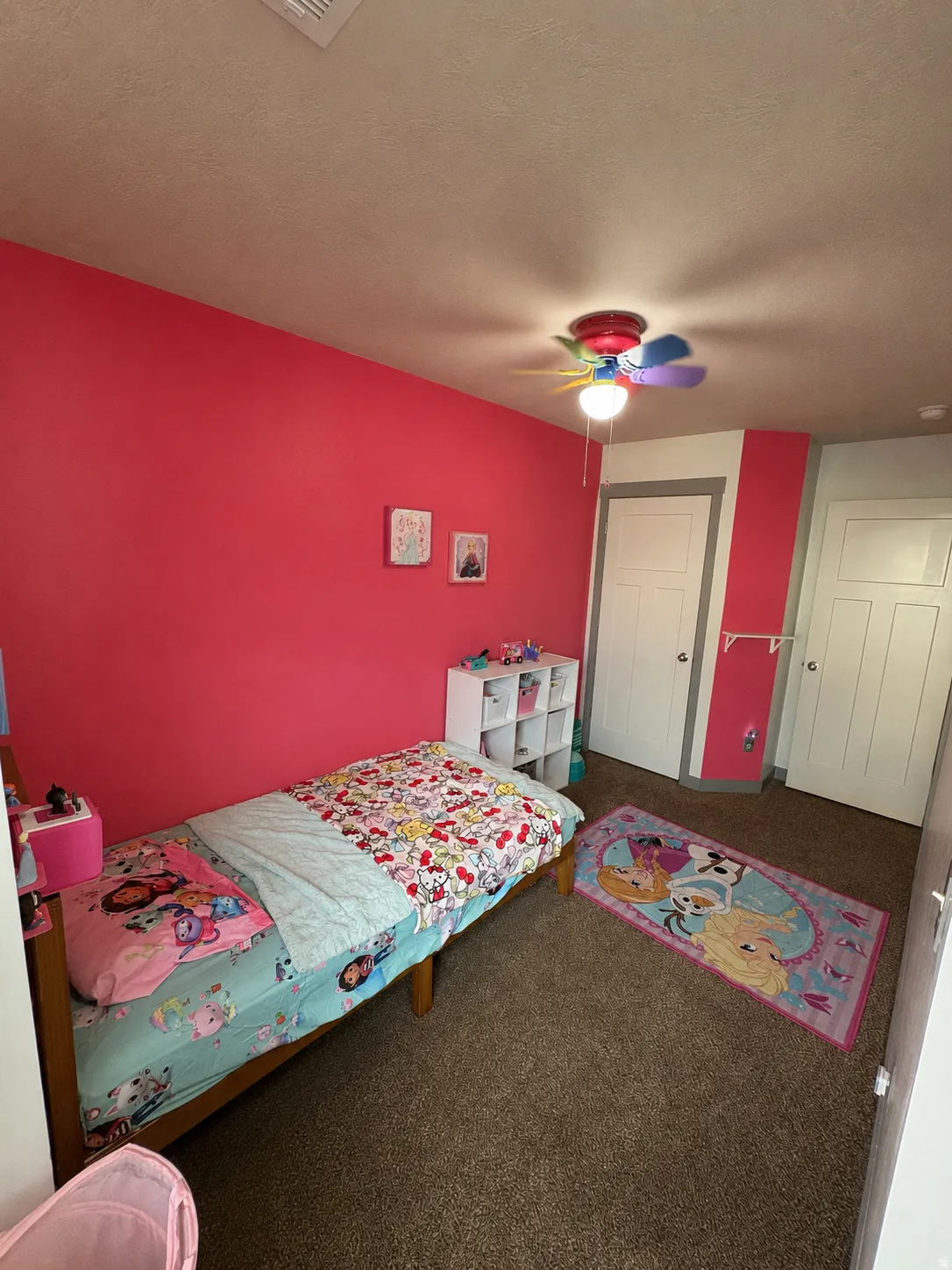 Room featuring textured carpeting, a textured ceiling, and a ceiling fan with light fixture
