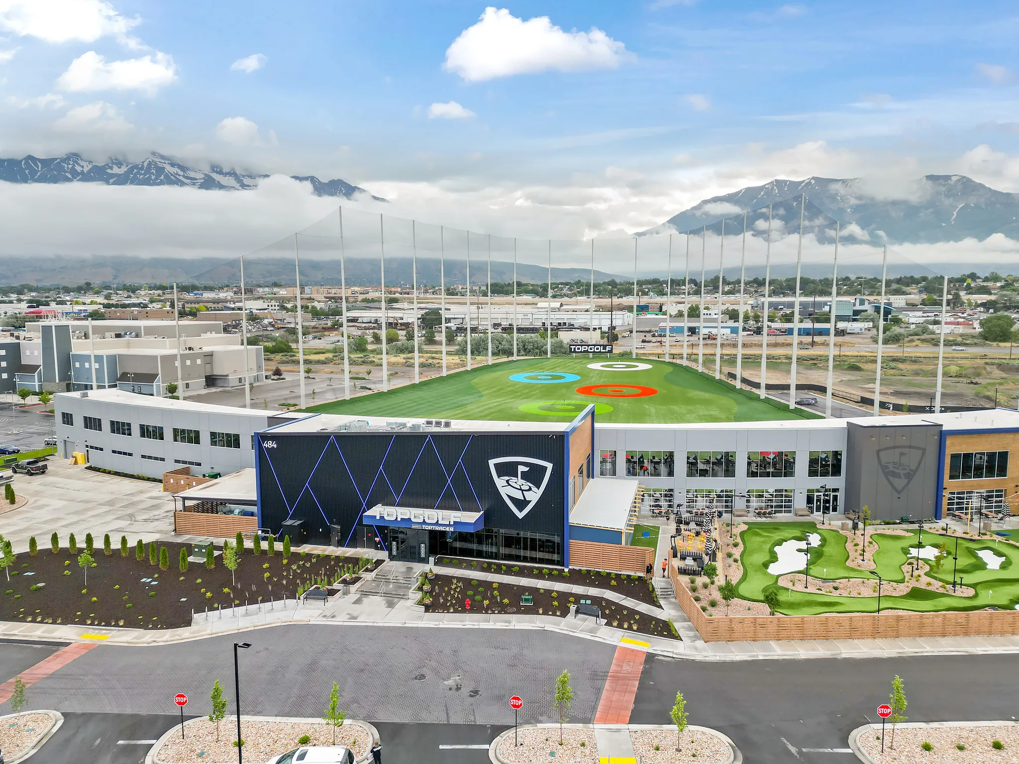 Modern recreational facility featuring a multi-level golf driving range and a miniature golf course