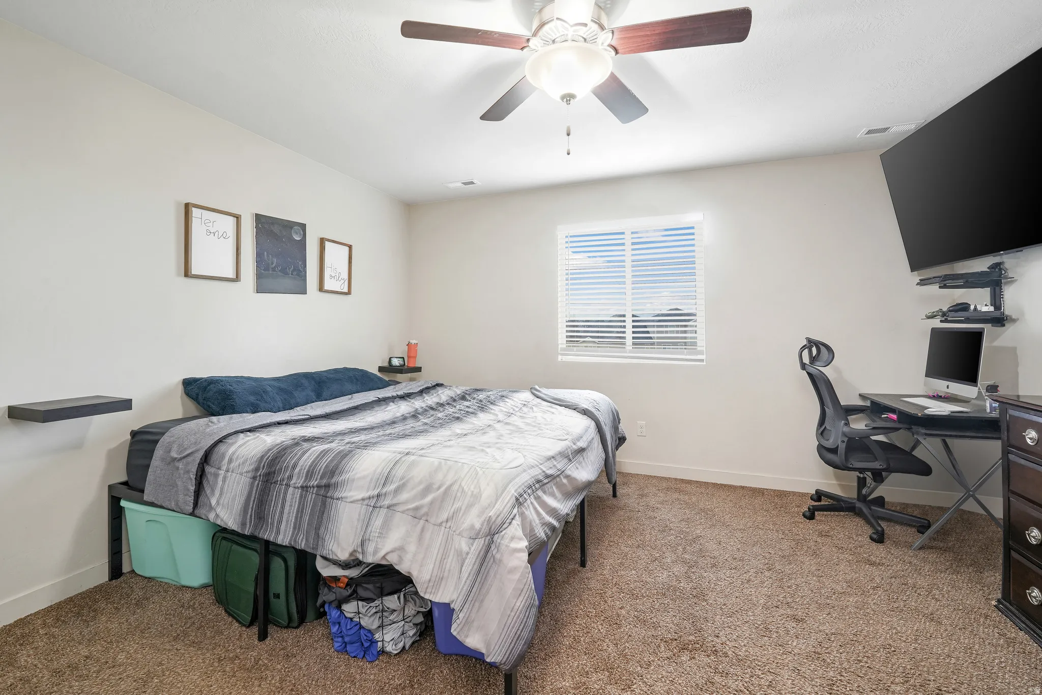 Carpeted room with a ceiling fan light fixture, a window with horizontal blinds, and neutral painted walls