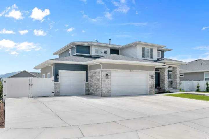 Contemporary two-story residence featuring a multi-tone exterior of stacked stone, horizontal siding, and stucco