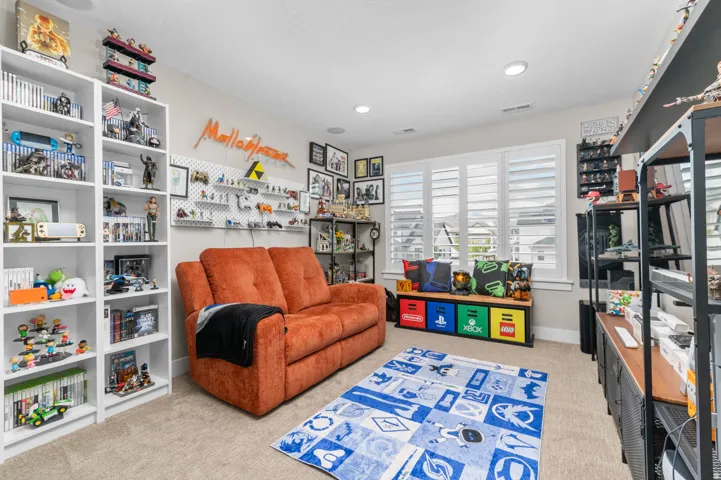 Carpeted interior room featuring recessed lighting and white plantation shutters
