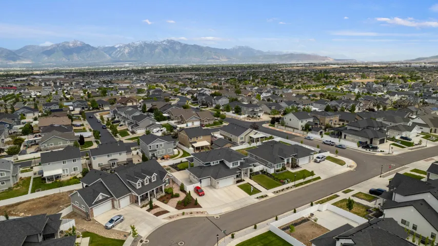Expansive residential community featuring a variety of architectural styles, paved streets, and mature landscaping