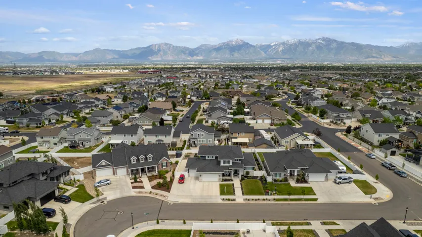 Spacious neighborhood with a consistent architectural style, featuring manicured lawns and paved streets