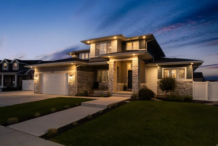 Contemporary two-story exterior featuring stone veneer and horizontal siding