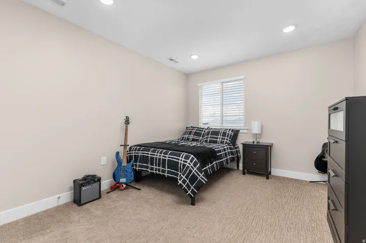 Room featuring neutral-toned walls, recessed lighting, and carpeted flooring