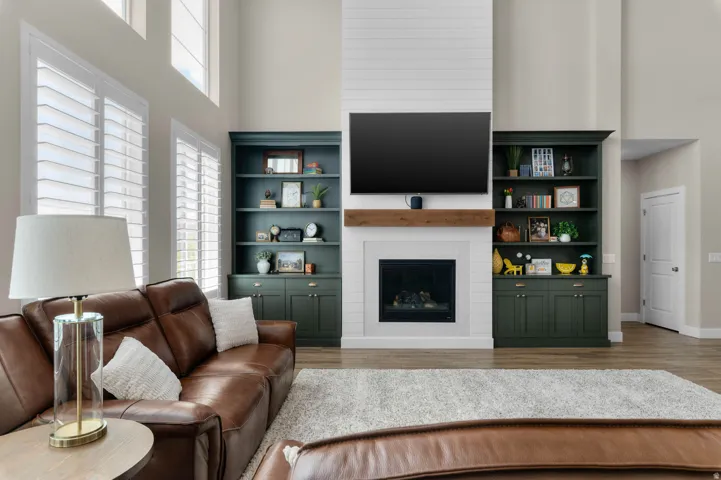 Living area featuring a tall fireplace with a wooden mantel and white shiplap accent wall