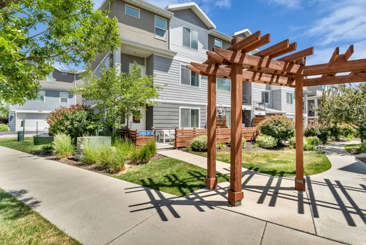Multi-level townhome exterior featuring contemporary siding and a private patio