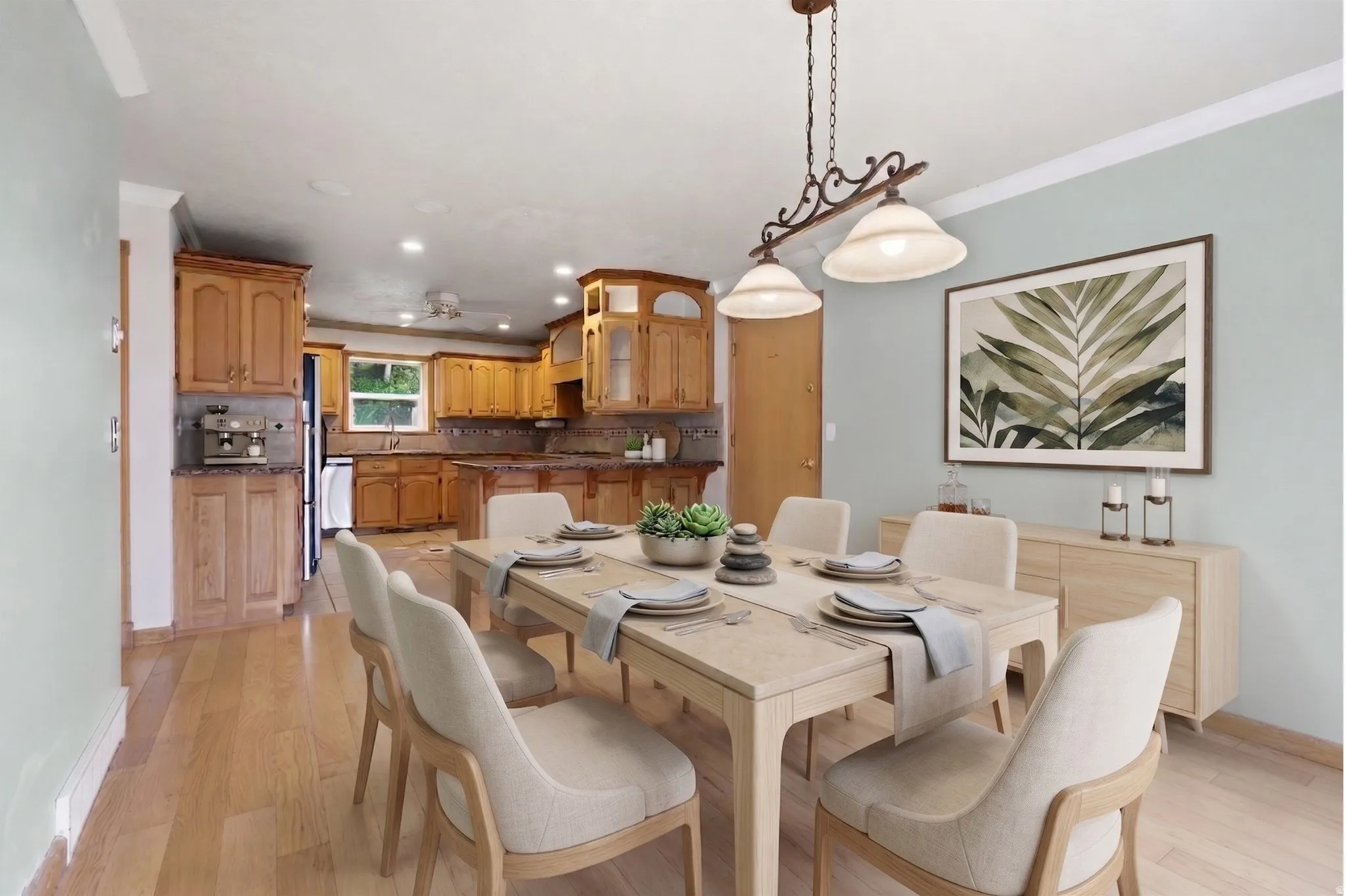 Open-concept dining area featuring wood-finish flooring, a decorative chandelier, and light-toned walls