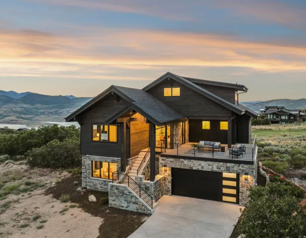 Contemporary architectural design featuring dark wood-finish siding and stone accents