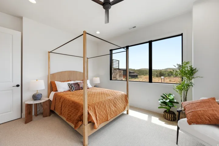 Spacious room with large picture windows, recessed lighting, and a ceiling fan
