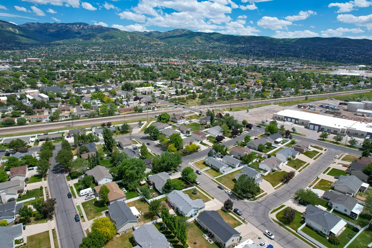 Residential neighborhood featuring established trees and a distant mountain backdrop