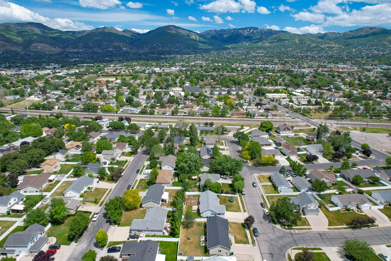 Aerial perspective showcasing an established residential neighborhood with mature trees