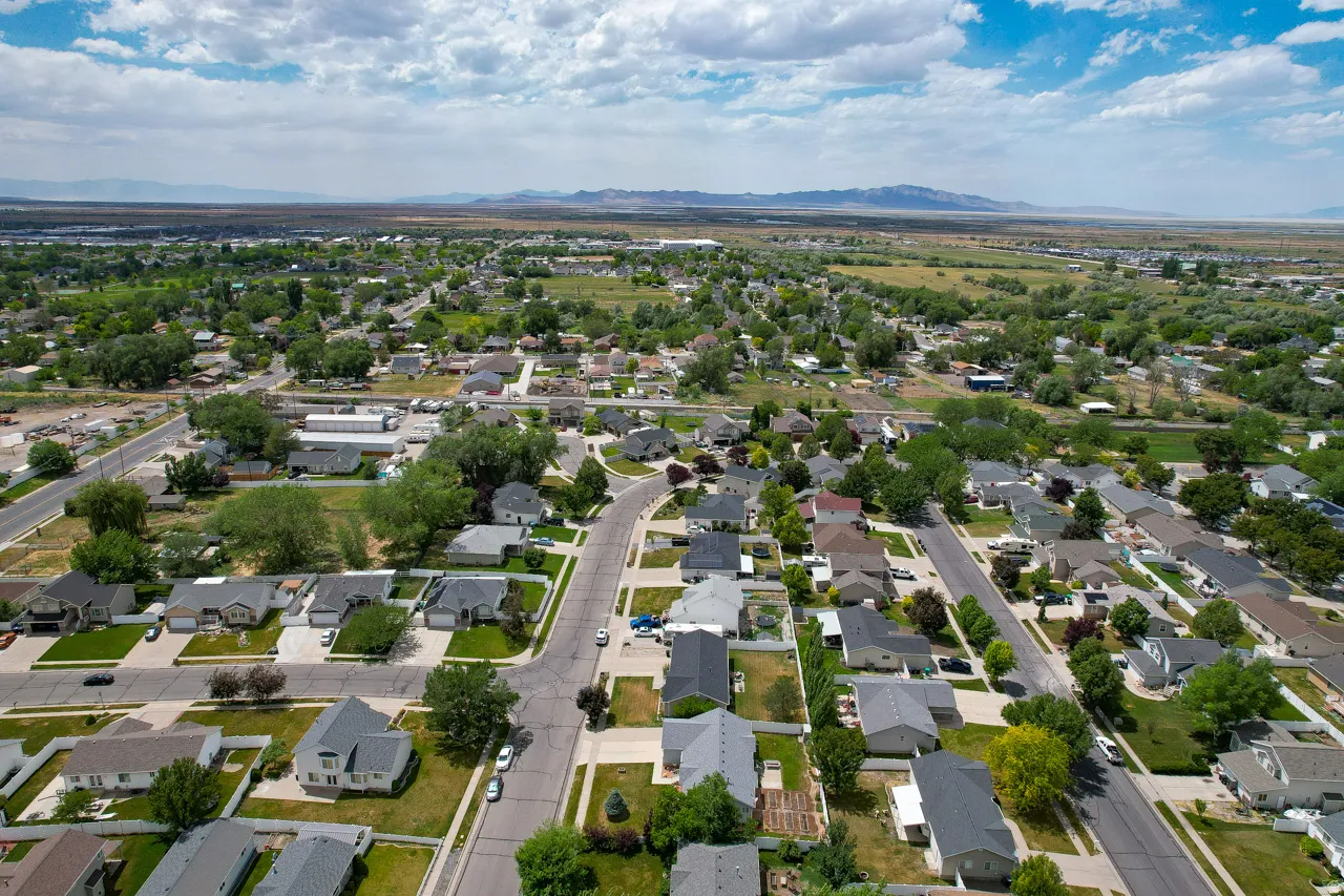 Residential neighborhood featuring a grid-style street layout, mature landscaping, and a distant mountain range
