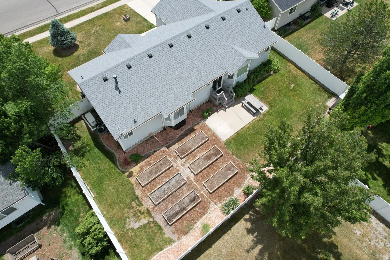 Rear exterior with a pitched shingle roof and light-toned siding