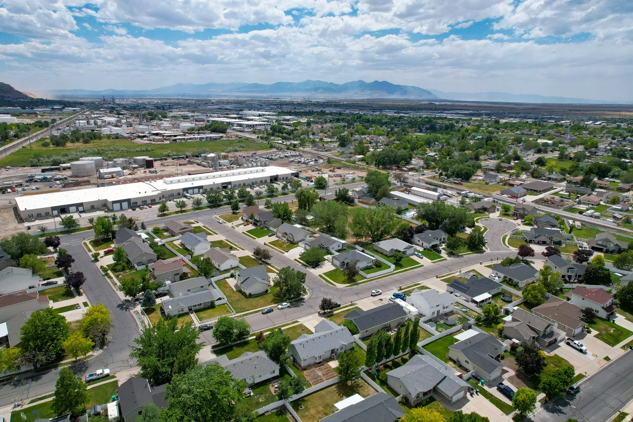 Aerial perspective of a residential community featuring single-story homes with varied rooflines