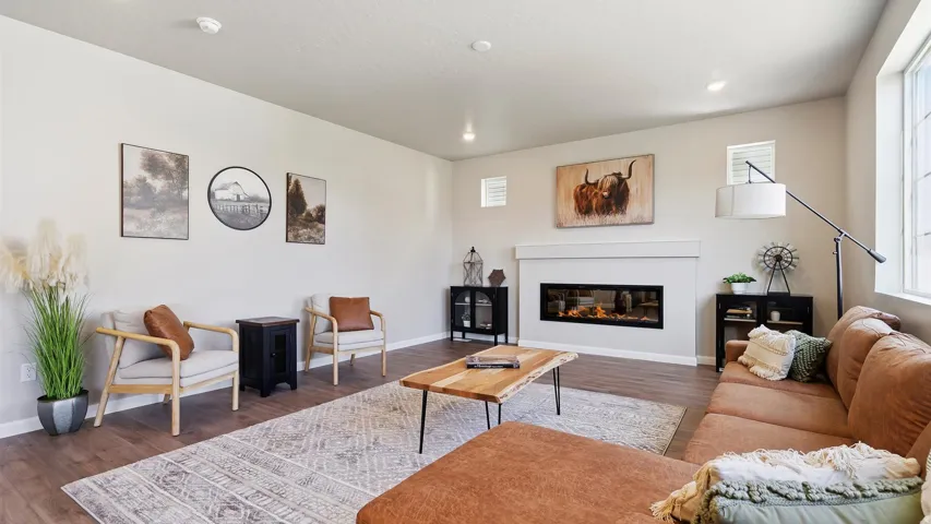 Spacious interior featuring wood-finish flooring, recessed lighting, and large windows