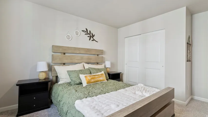 Neutral-toned walls complement the light-colored carpet flooring