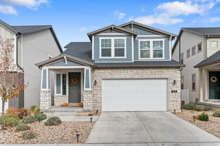 Stone and siding exterior with an integrated two-car garage