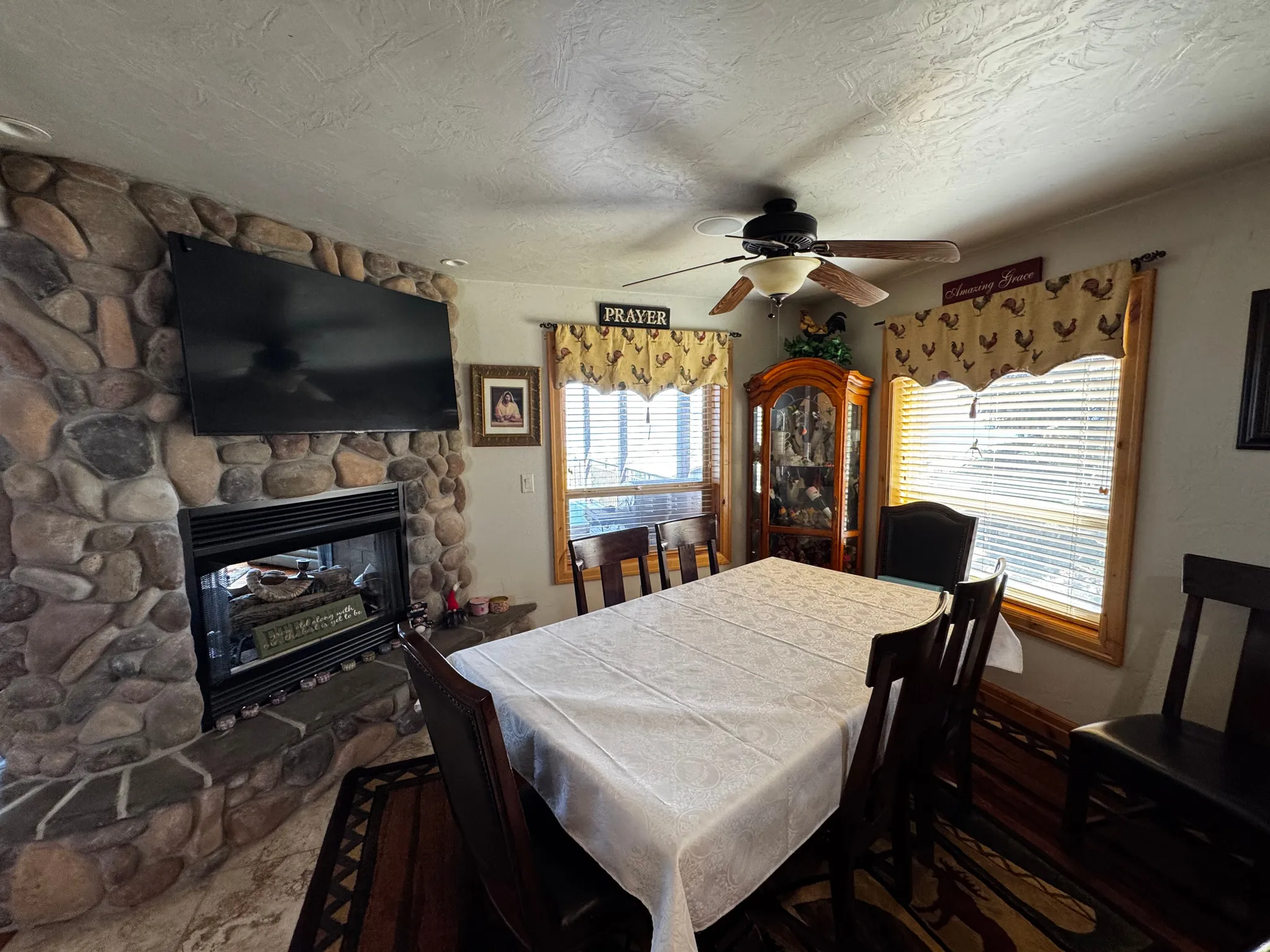 Dining area featuring a stone-clad fireplace and hearth