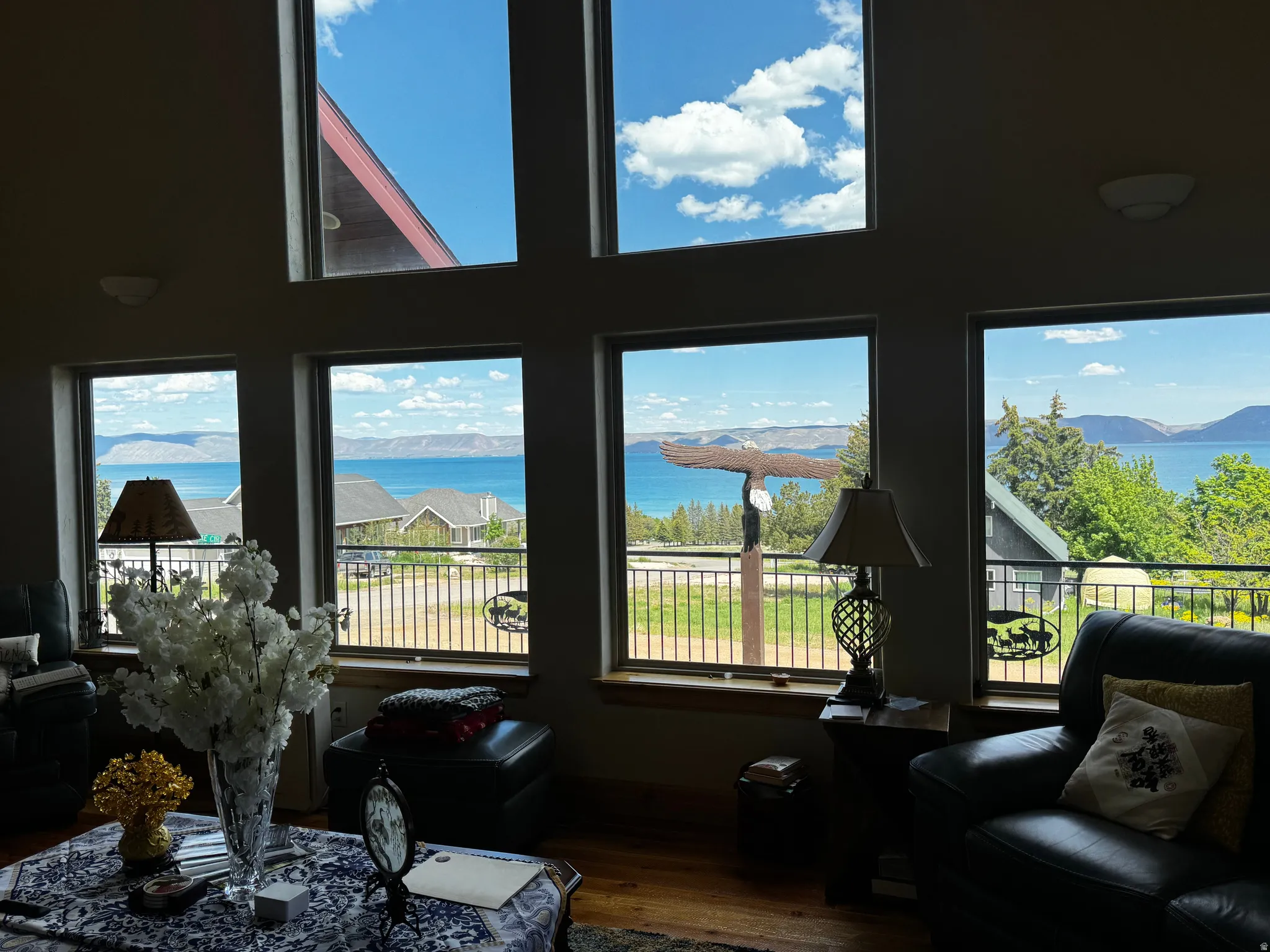 Expansive windows offering panoramic water and mountain scenery