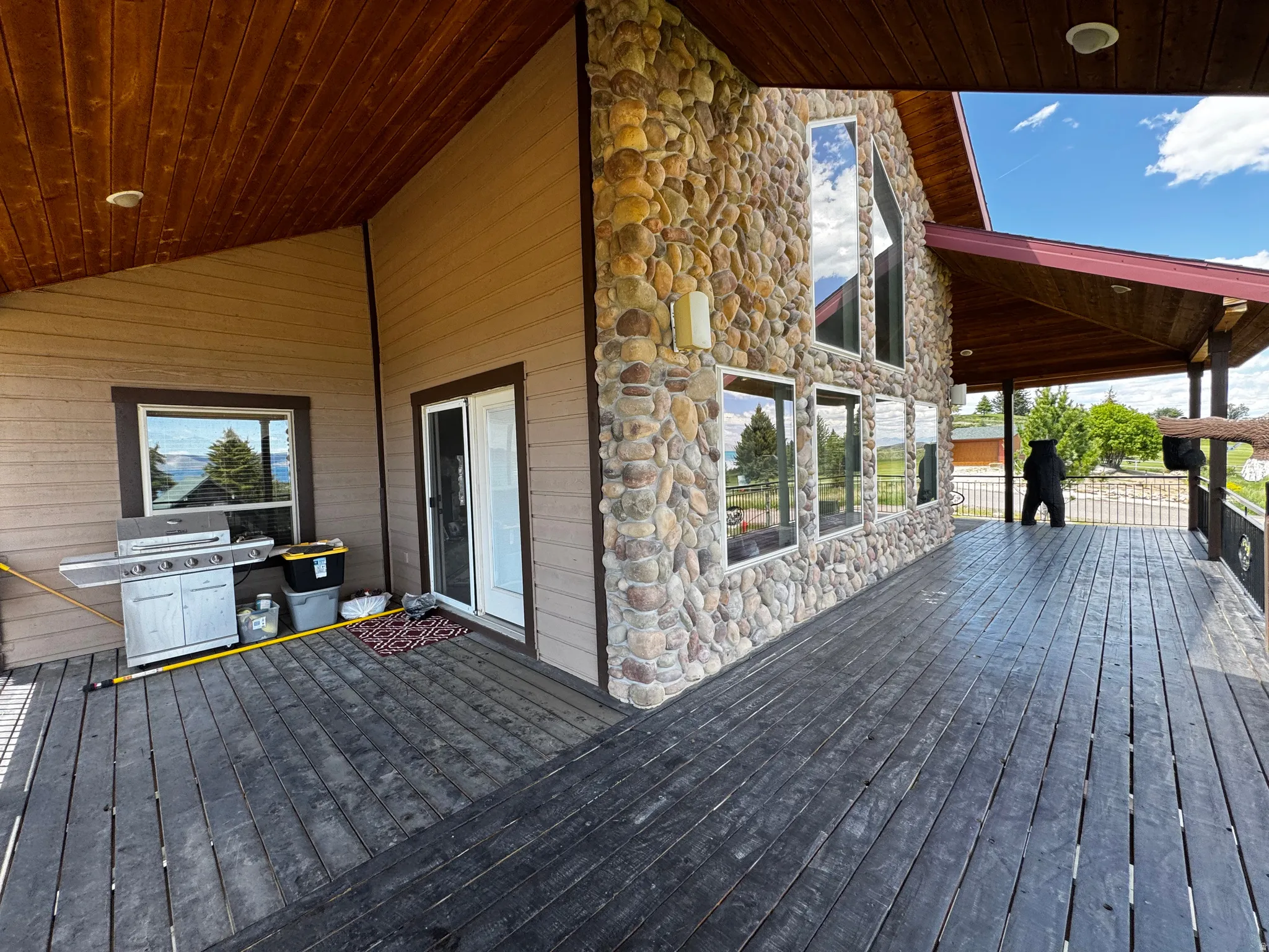 Expansive exterior deck featuring dark wood-finish flooring