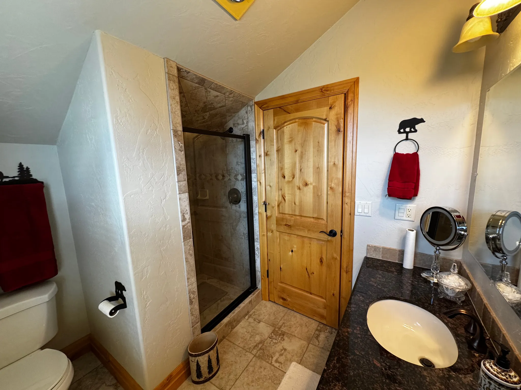 Bathroom featuring a granite-finish countertop, undermount sink, and dark bronze-finish faucet