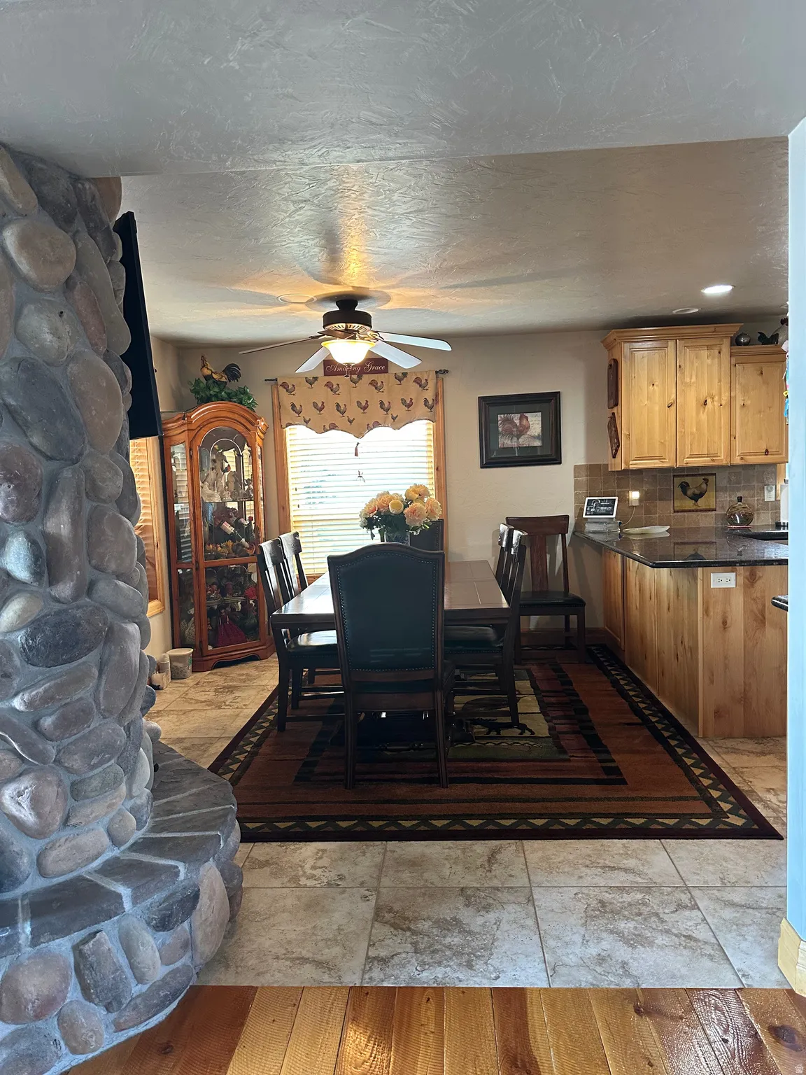 Stone-clad fireplace feature, wood-finish flooring, tiled flooring, wood cabinetry, and recessed lighting