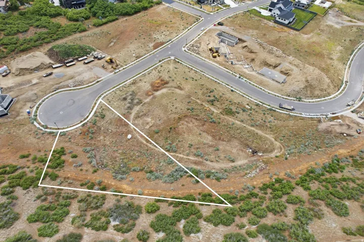 Expansive parcel featuring undeveloped land bordered by established roadways