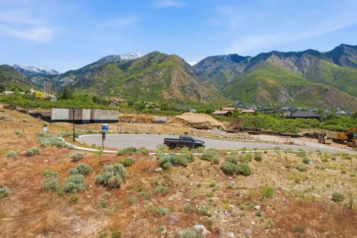 Mountainous terrain backdrop featuring a partial concrete foundation on a building site