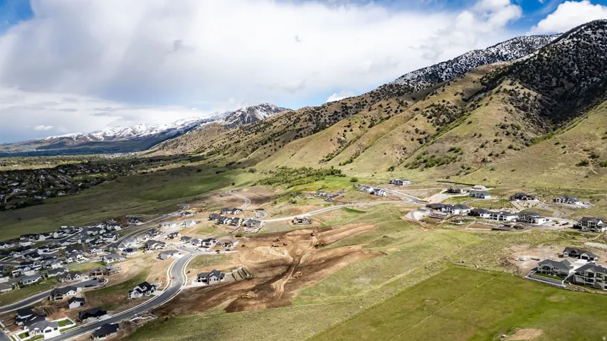 Aerial perspective showcasing a mountain backdrop with snow-capped peaks
