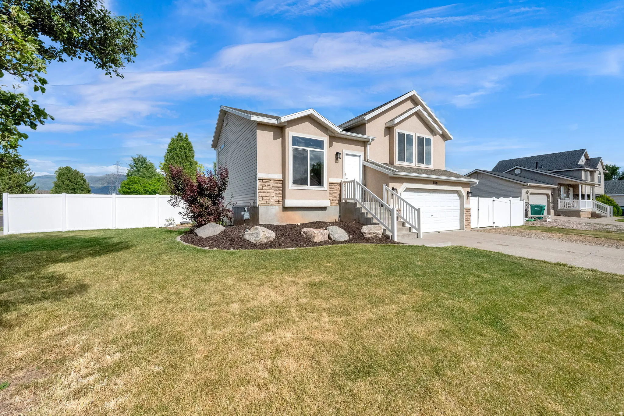Two-story exterior with stucco and stone veneer accents