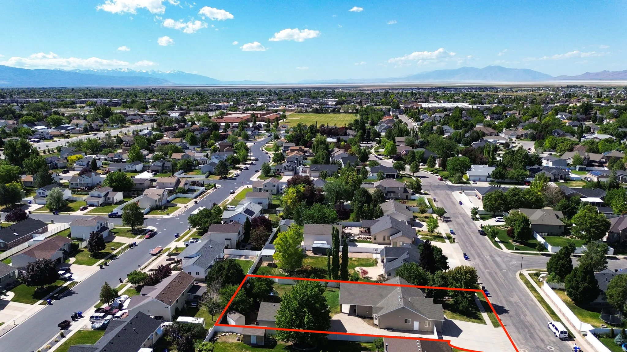 Aerial perspective showcasing a residential neighborhood with distant mountain ranges
