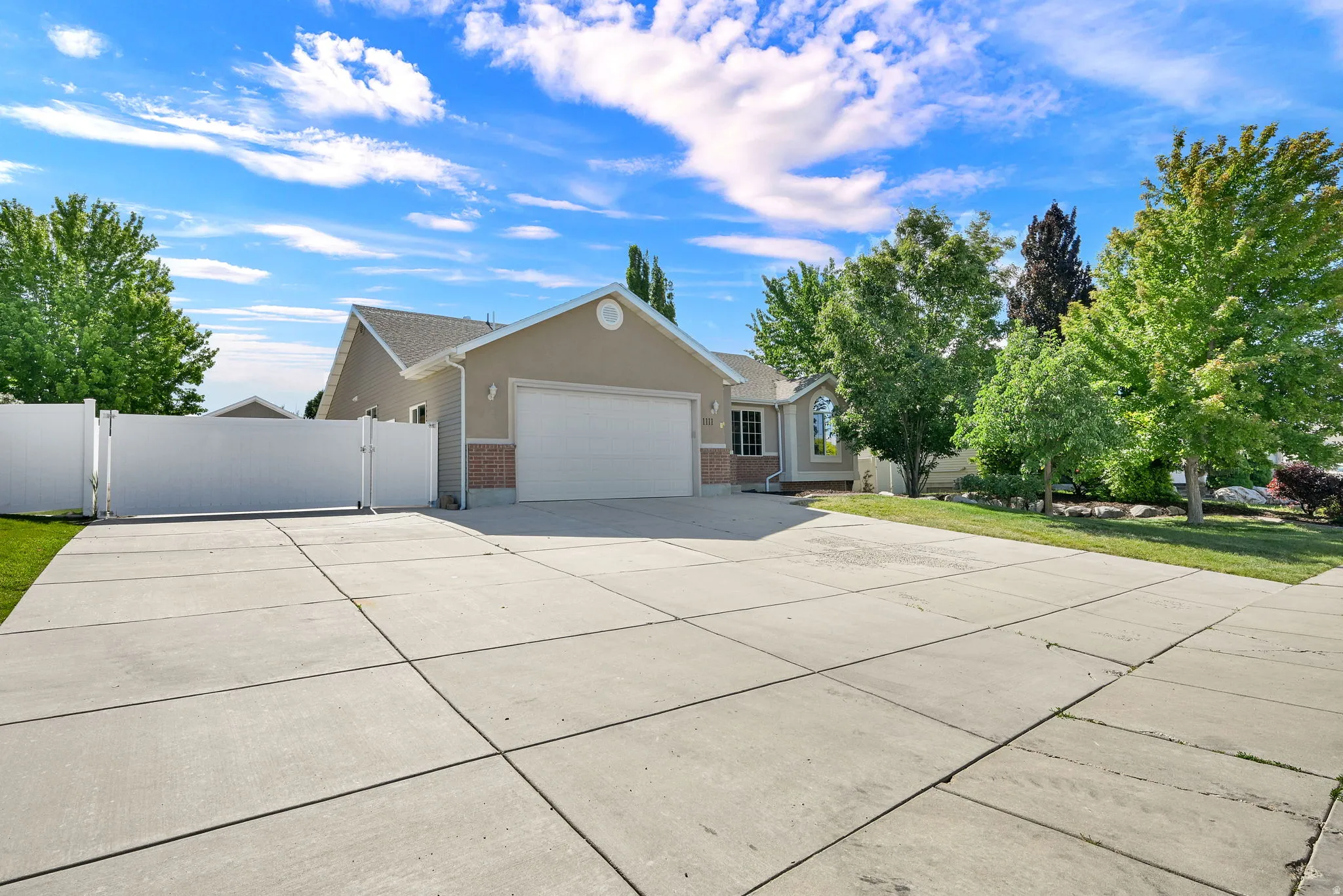 Expansive concrete driveway and two-car garage