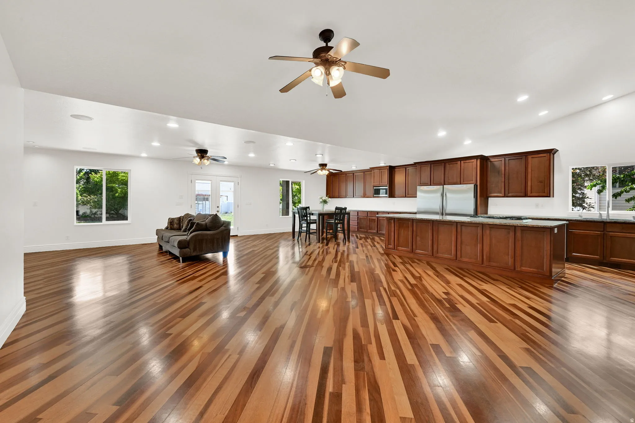 Expansive open-concept living area featuring rich wood flooring throughout
