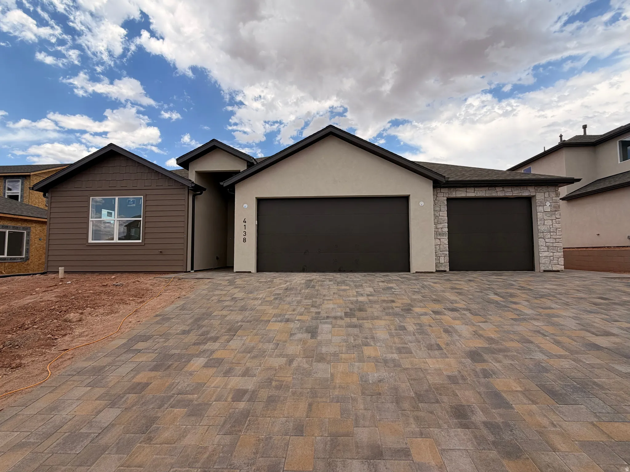 Contemporary exterior featuring stucco, horizontal siding, and stone accents