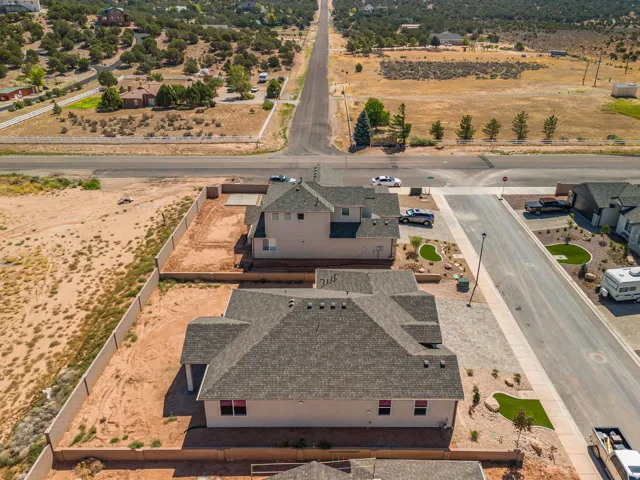 Contemporary residential property with a multi-pitch shingle roof and stucco exterior