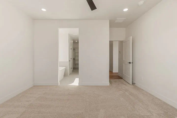 Carpeted interior space featuring recessed lighting and a ceiling fan