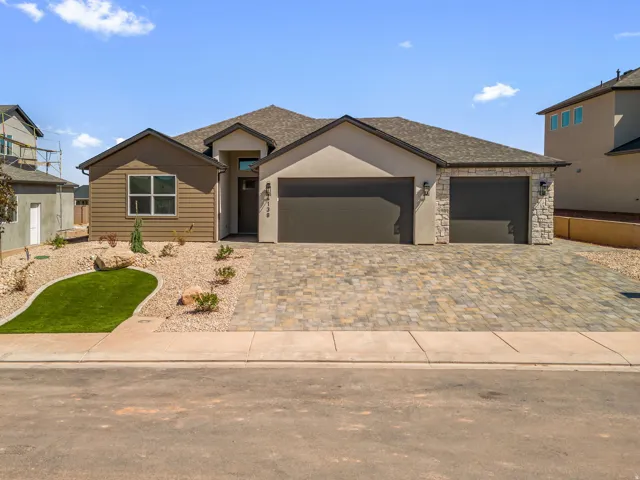 Contemporary exterior featuring stucco and horizontal siding with stone accents