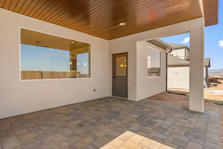 Covered patio featuring multi-toned paver flooring, a wood-finish ceiling, and recessed lighting
