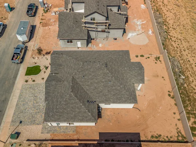 Aerial perspective of a newly constructed residence featuring a gray shingle roof and white exterior siding