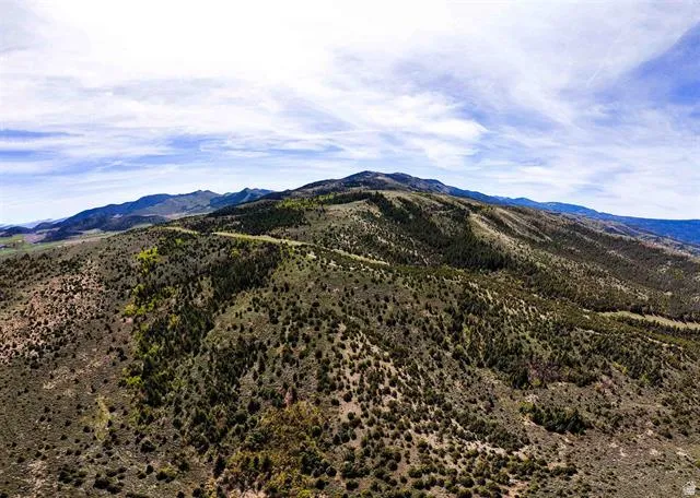 Expansive mountain landscape featuring varied terrain and natural vegetation