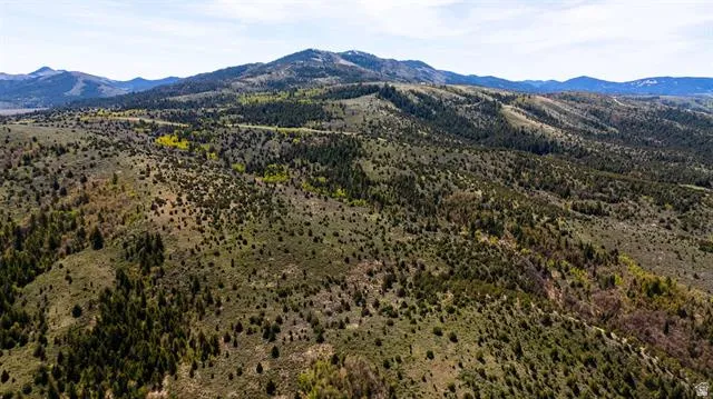 Expansive mountain landscape featuring varied topography with rolling hills and distant peaks