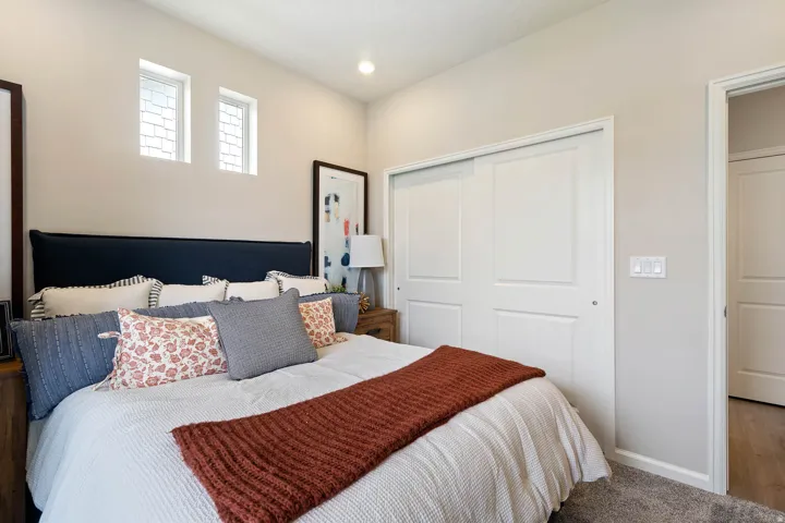Bedroom featuring two transom windows, recessed lighting, and a neutral color palette