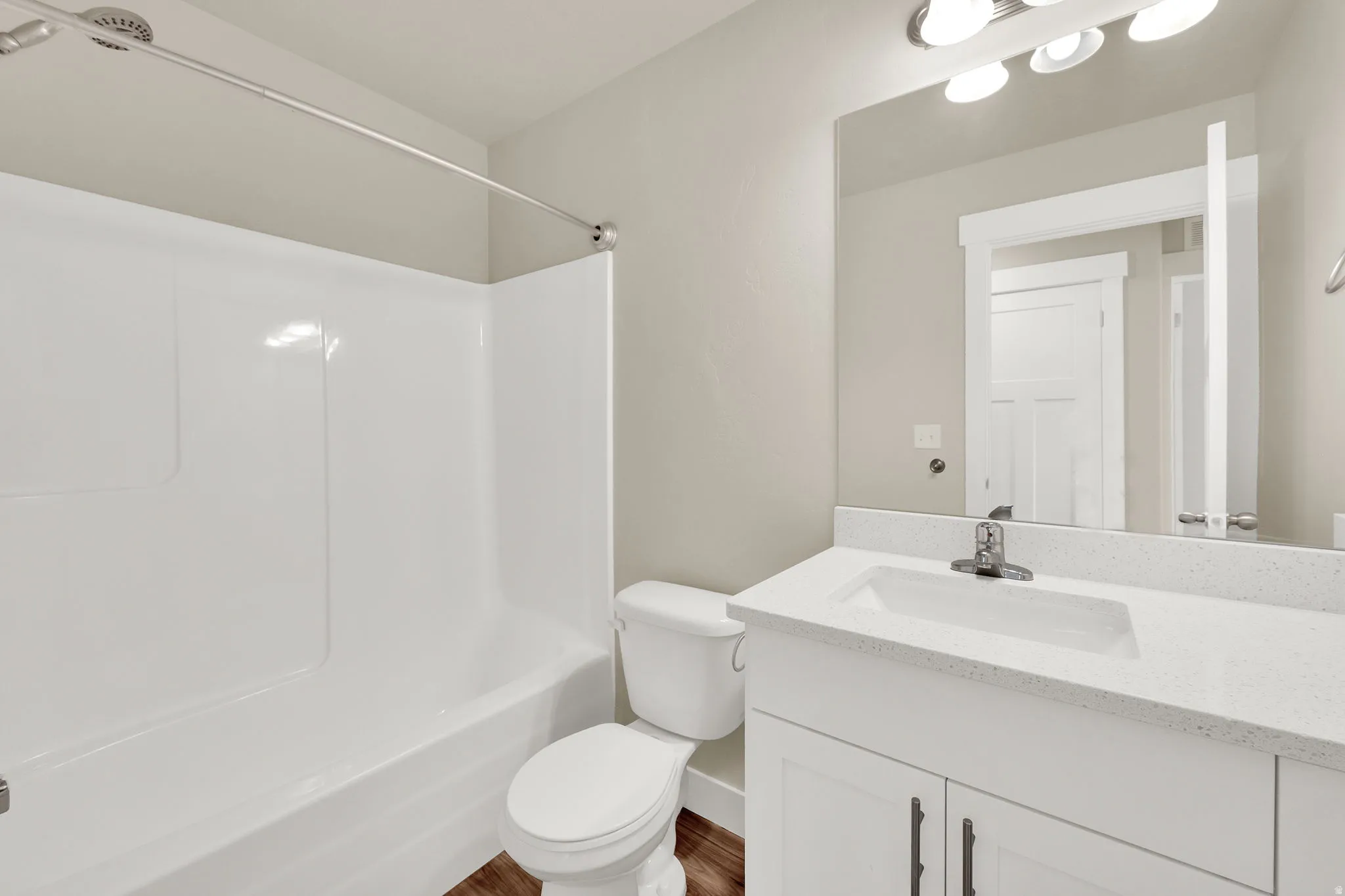Bathroom featuring a white integrated tub and shower unit
