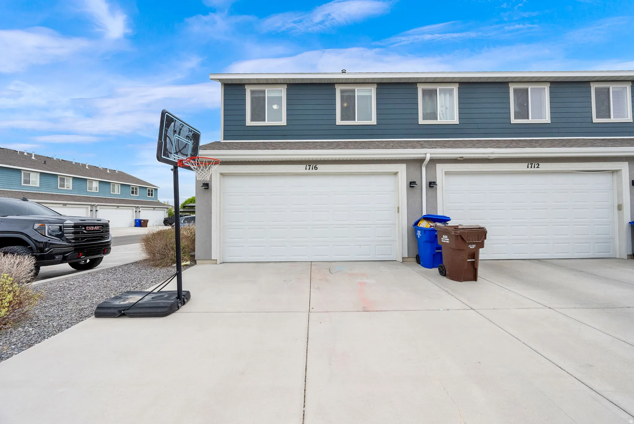 Townhome exterior featuring blue siding and white trim