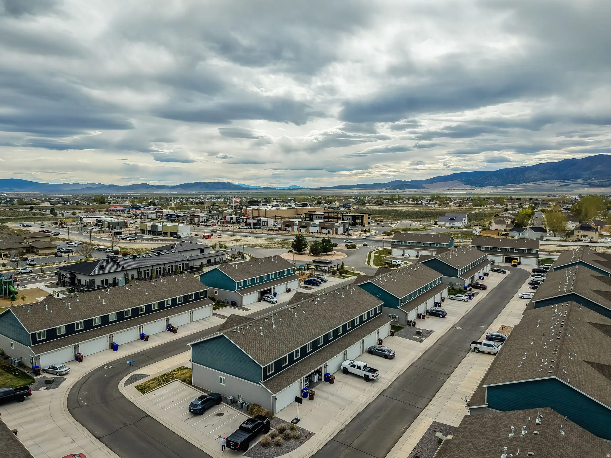 Aerial perspective showcasing a residential community with multiple townhome-style buildings