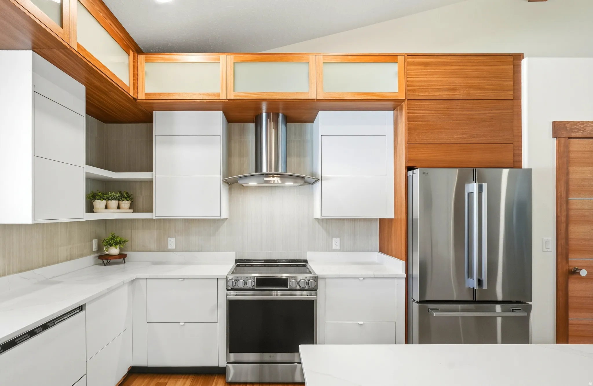 Kitchen cabinet boxes are fully adjustable while the cabinet faces are a quarter sawn Mahogany venner, push-to-open with a 7 yr warranty while the induction heated oven has gas AND electric both available.