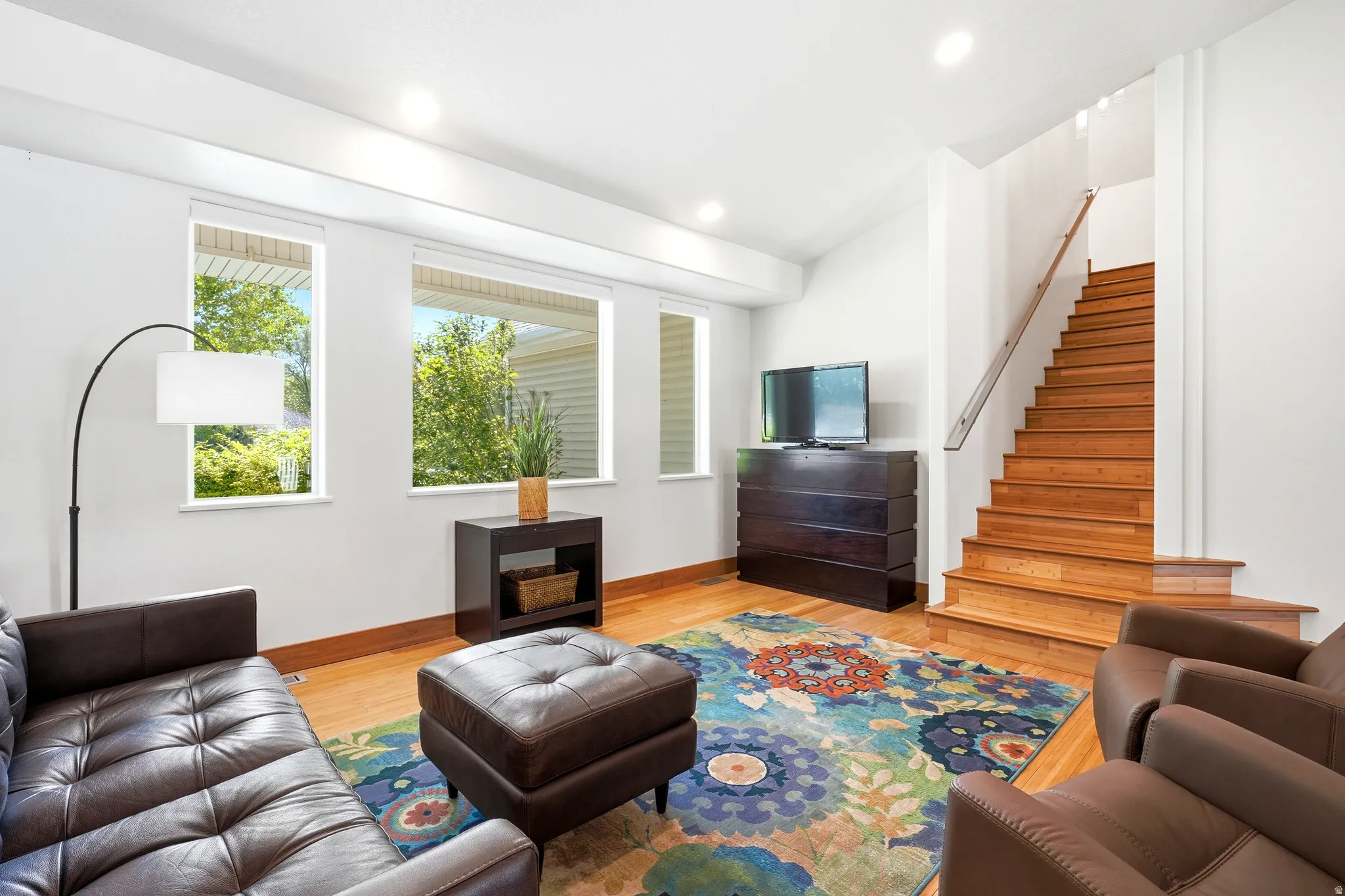Fresh bamboo flooring and new window shades enhance the home with warmth, light, and modern appeal