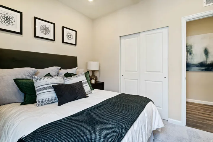Recessed lighting illuminates neutral walls and light-toned carpeting