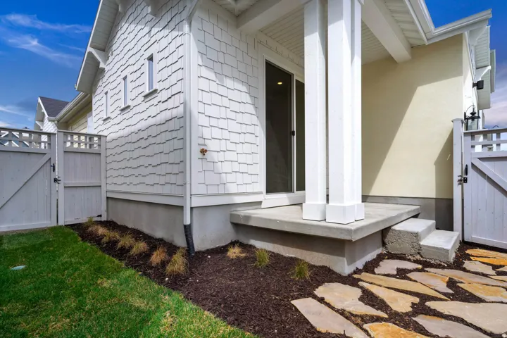 Exterior with white shingle siding and stucco accents